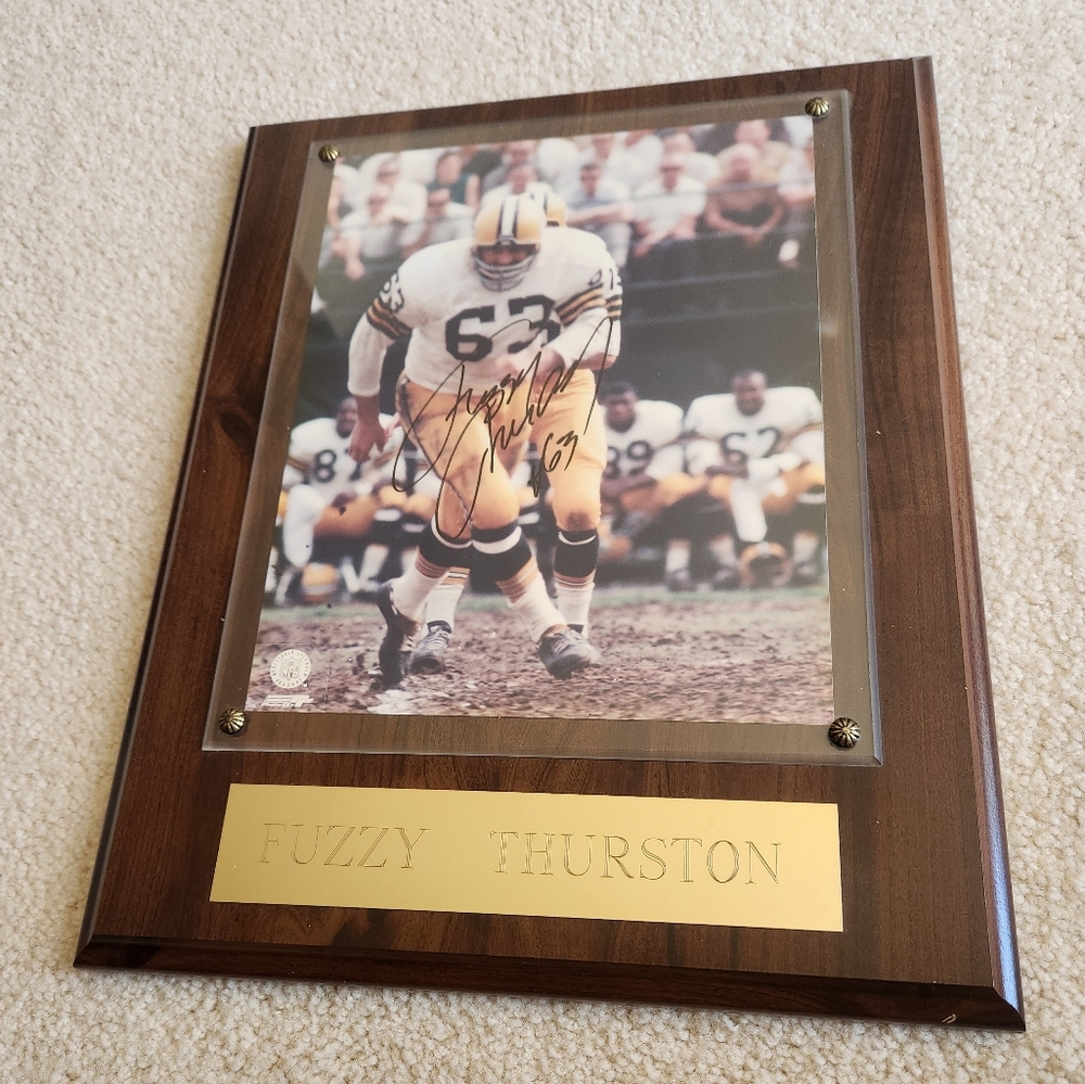 Signed Green Bay Packers #63 Fuzzy Thurston photograph mounted with name plate.